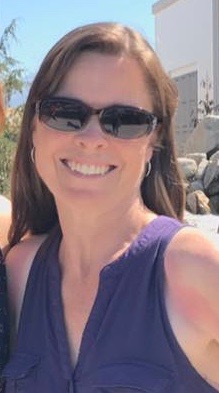 a smiling woman in sunglasses
